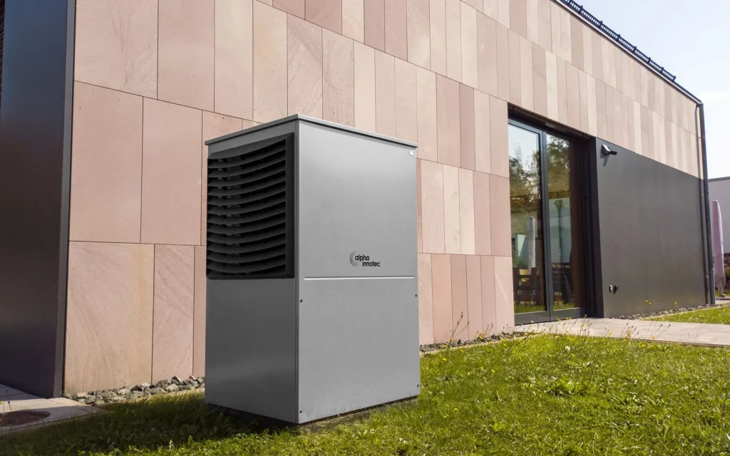 Heat pump hot water unit installed outside a house